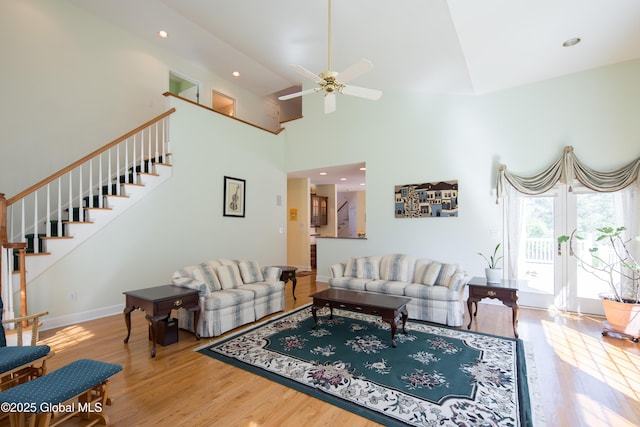 1 Avalon Ct, Colonie, NY 12211 - living area featuring wood finished floors, stairs, high vaulted ceiling, ceiling fan, and baseboards