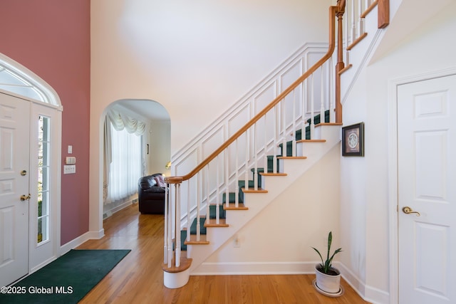 1 Avalon Ct, Colonie, NY 12211 - foyer featuring arched walkways, stairs, wood finished floors, baseboards, and a towering ceiling