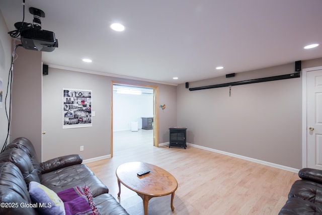 1 Avalon Ct, Colonie, NY 12211 - living area featuring light wood-style flooring, a wood stove, recessed lighting, and baseboards