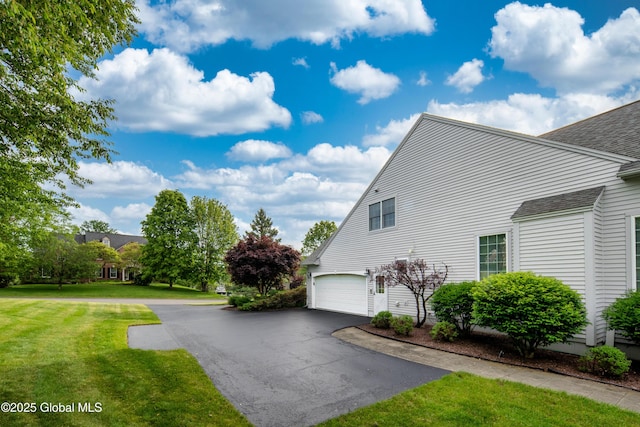 1 Avalon Ct, Colonie, NY 12211 - view of side of home featuring a garage, a lawn, roof with shingles, and driveway