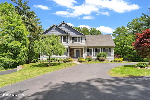 151 Edie Rd, Wilton, NY 12866 - traditional home featuring a front lawn and asphalt driveway