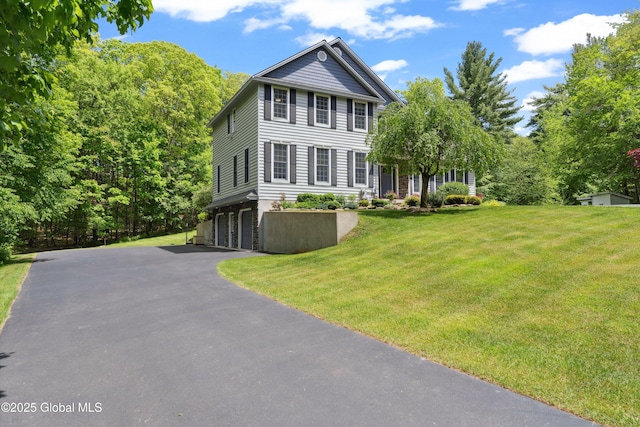 151 Edie Rd, Wilton, NY 12866 - view of front facade with a garage, asphalt driveway, and a front yard