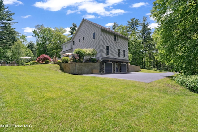 151 Edie Rd, Wilton, NY 12866 - view of side of property with a garage, a lawn, asphalt driveway, and stone siding