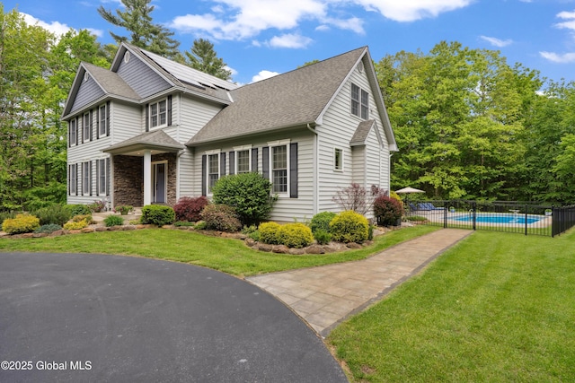151 Edie Rd, Wilton, NY 12866 - view of front of home with a shingled roof, stone siding, and solar panels