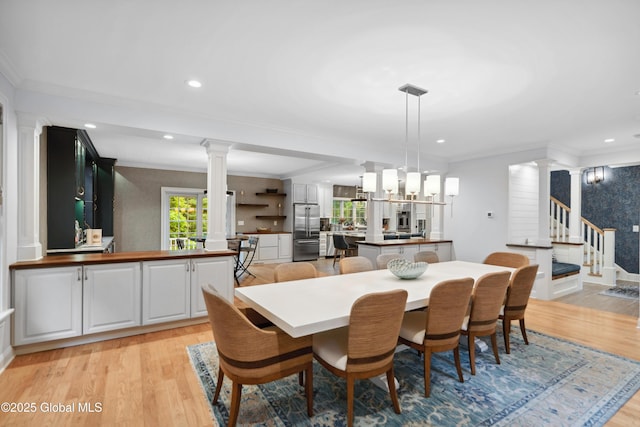 151 Edie Rd, Wilton, NY 12866 - dining room with decorative columns, light wood finished floors, crown molding, stairs, and recessed lighting