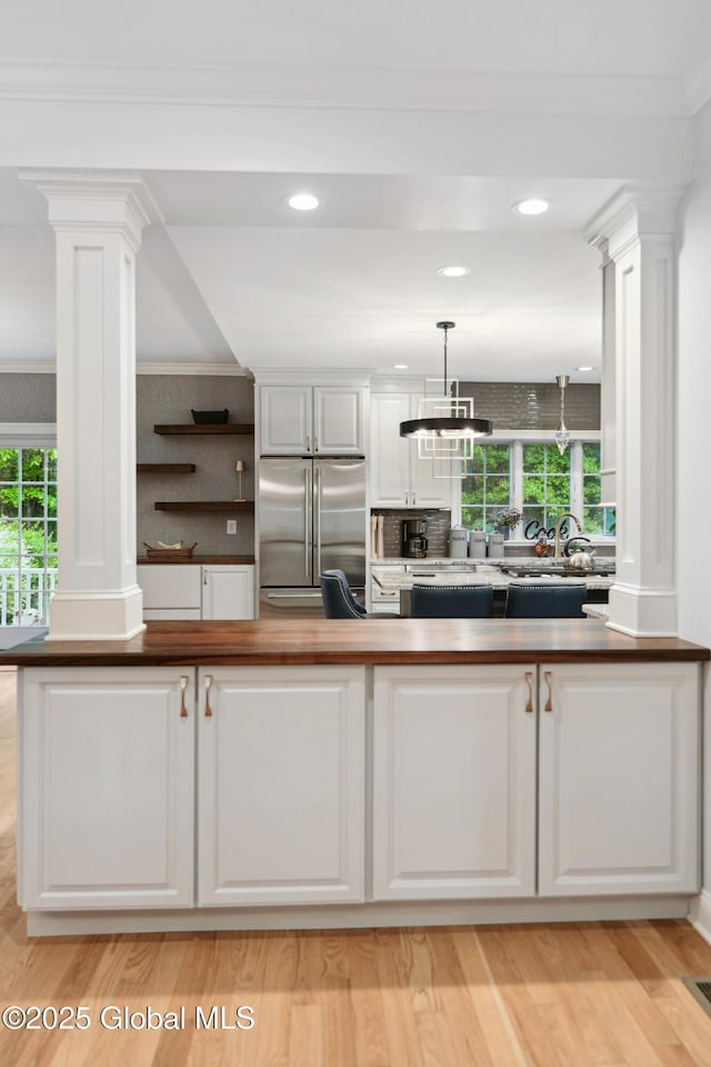 151 Edie Rd, Wilton, NY 12866 - kitchen with built in fridge, decorative columns, plenty of natural light, ornamental molding, and recessed lighting