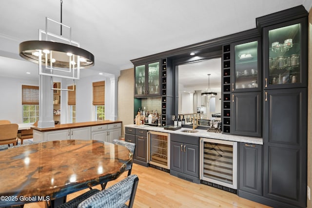 151 Edie Rd, Wilton, NY 12866 - indoor wet bar featuring beverage cooler, a chandelier, light wood finished floors, ornamental molding, and recessed lighting