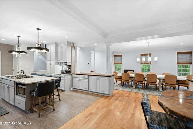 151 Edie Rd, Wilton, NY 12866 - kitchen featuring a kitchen island, light wood-style flooring, recessed lighting, ornate columns, and appliances with stainless steel finishes