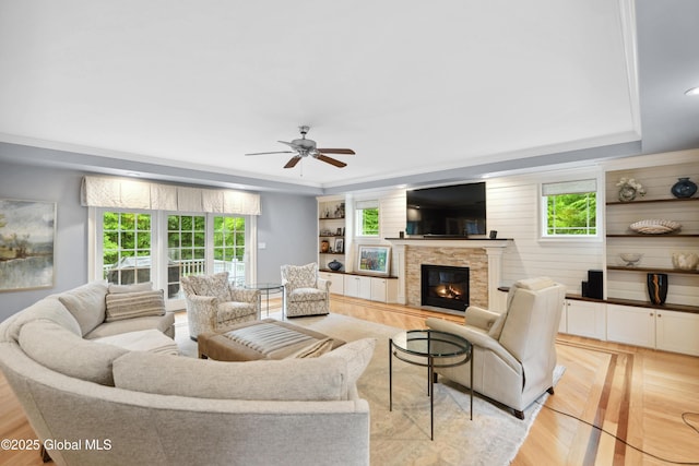 151 Edie Rd, Wilton, NY 12866 - living room featuring a glass covered fireplace, ceiling fan, and a raised ceiling