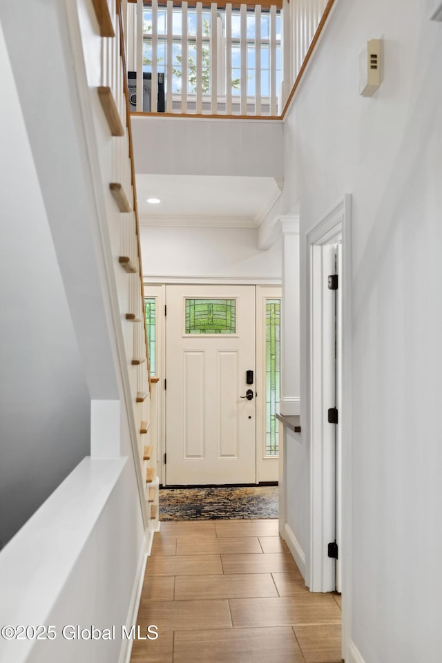 151 Edie Rd, Wilton, NY 12866 - foyer entrance featuring stairs, crown molding, wood finished floors, baseboards, and a towering ceiling