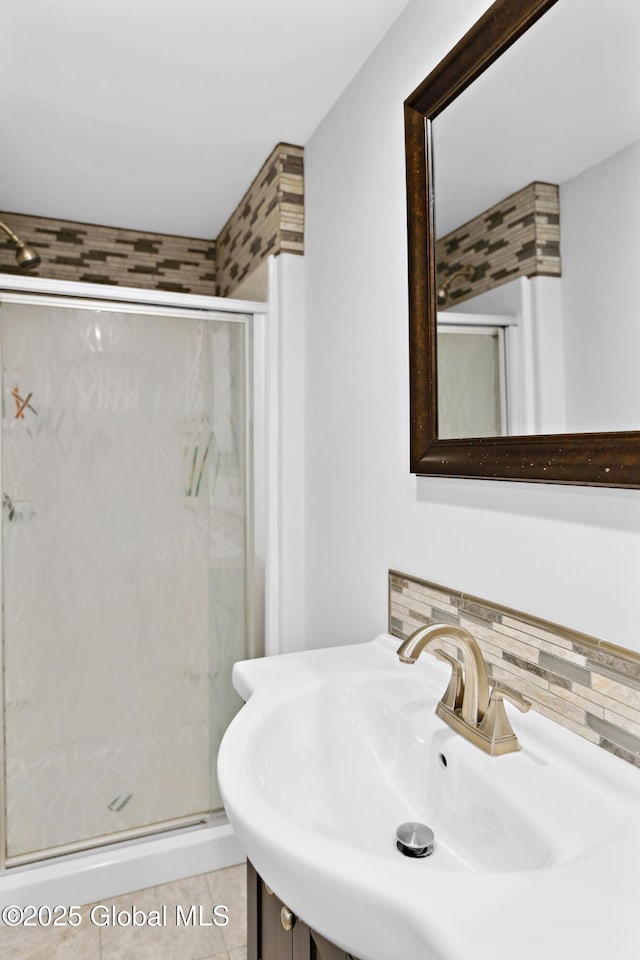 151 Edie Rd, Wilton, NY 12866 - bathroom with a shower stall, a sink, decorative backsplash, and tile patterned flooring