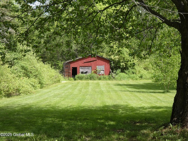 2541 N Line Rd, Galway, NY 12074 - view of green lawn with a forest view, an outbuilding, and a detached garage