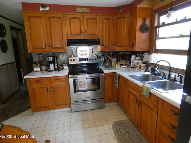 2541 N Line Rd, Galway, NY 12074 - kitchen with electric range, under cabinet range hood, brown cabinets, and light countertops
