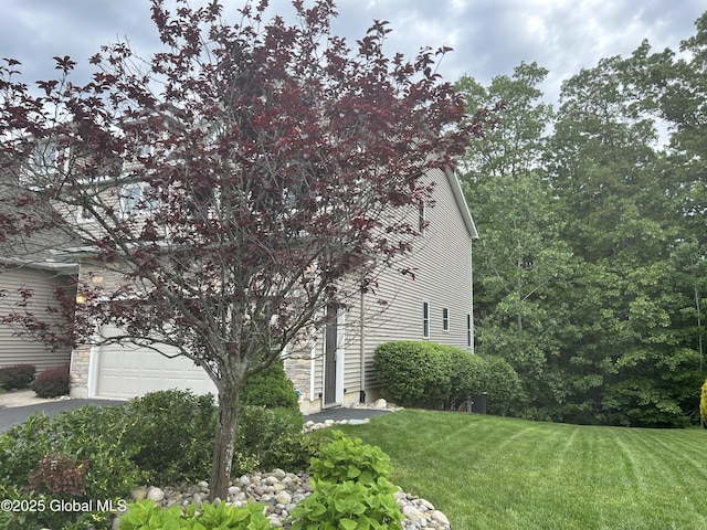 181 Fieldstone Dr, Niskayuna, NY 12304 - view of property exterior featuring a lawn, a garage, and driveway