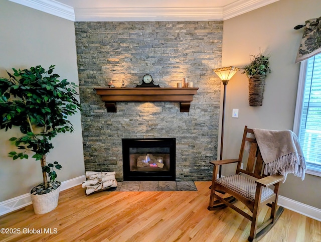 181 Fieldstone Dr, Niskayuna, NY 12304 - sitting room featuring crown molding, healthy amount of natural light, wood finished floors, baseboards, and a stone fireplace