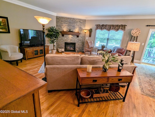 181 Fieldstone Dr, Niskayuna, NY 12304 - living room featuring light wood-style flooring, a stone fireplace, plenty of natural light, and crown molding
