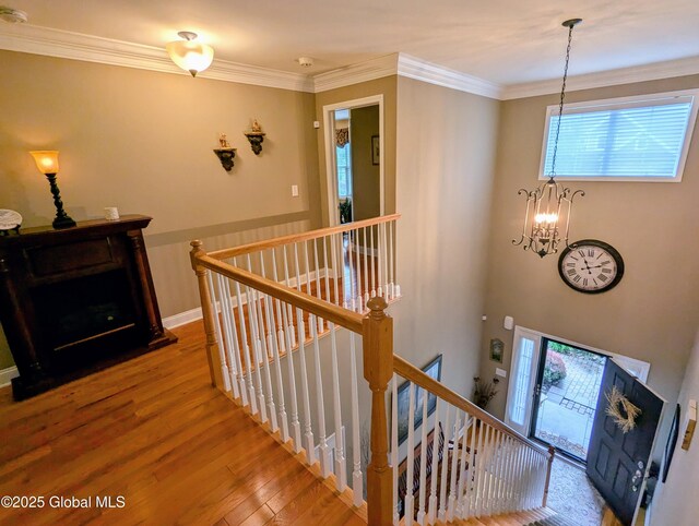 181 Fieldstone Dr, Niskayuna, NY 12304 - staircase with a chandelier, wood finished floors, and crown molding