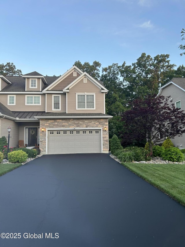 181 Fieldstone Dr, Niskayuna, NY 12304 - view of front of house with an attached garage, asphalt driveway, and stone siding