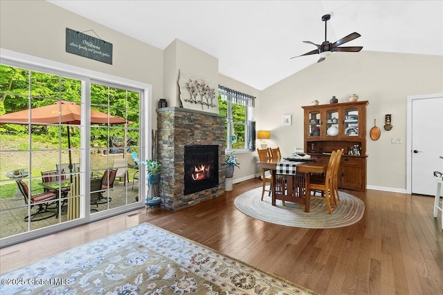 33 White Birch Dr, Lake Luzerne, NY 12846 - dining space featuring ceiling fan, hardwood / wood-style flooring, a fireplace, baseboards, and high vaulted ceiling