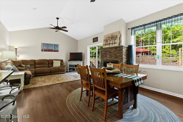33 White Birch Dr, Lake Luzerne, NY 12846 - dining room featuring a ceiling fan, wood finished floors, vaulted ceiling, baseboards, and a fireplace