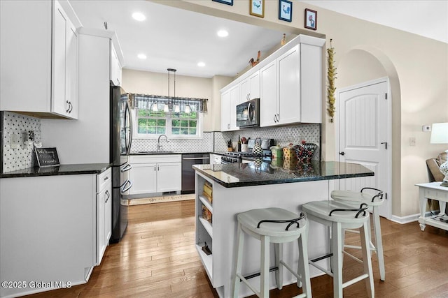 33 White Birch Dr, Lake Luzerne, NY 12846 - kitchen featuring stove, black microwave, a sink, stainless steel dishwasher, and freestanding refrigerator