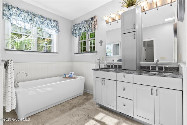 33 White Birch Dr, Lake Luzerne, NY 12846 - bathroom with double vanity, a wainscoted wall, and a bathtub