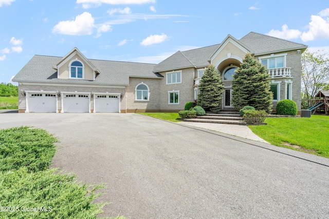 1310 Currybush Rd, Rotterdam, NY 12306 - view of front of home featuring driveway, a garage, a front lawn, cooling unit, and a playground