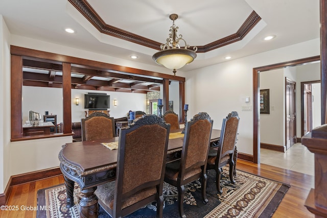 1310 Currybush Rd, Rotterdam, NY 12306 - dining room with baseboards, ornamental molding, a tray ceiling, recessed lighting, and light wood-style flooring