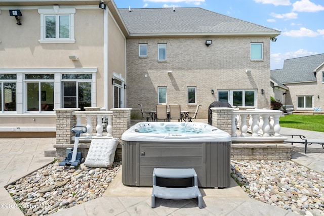 1310 Currybush Rd, Rotterdam, NY 12306 - back of house featuring a hot tub, a patio, brick siding, and a shingled roof