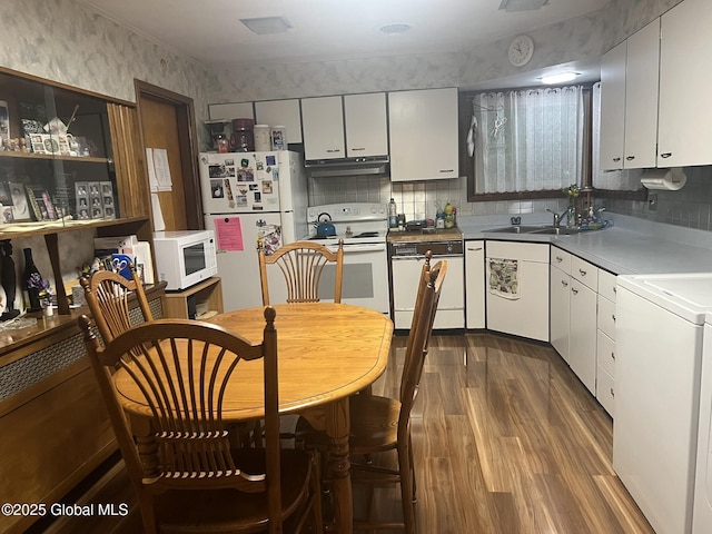 9 Potter St, Glens Falls, NY 12801 - kitchen featuring white appliances, under cabinet range hood, a sink, dark wood-style flooring, and washer / clothes dryer