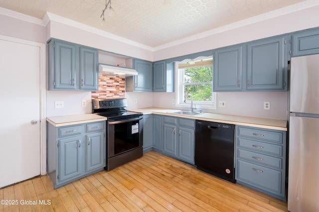 78 Dewitt Ave, Schenectady, NY 12304 - kitchen with stainless steel appliances, a sink, blue cabinetry, light countertops, and light wood-style flooring
