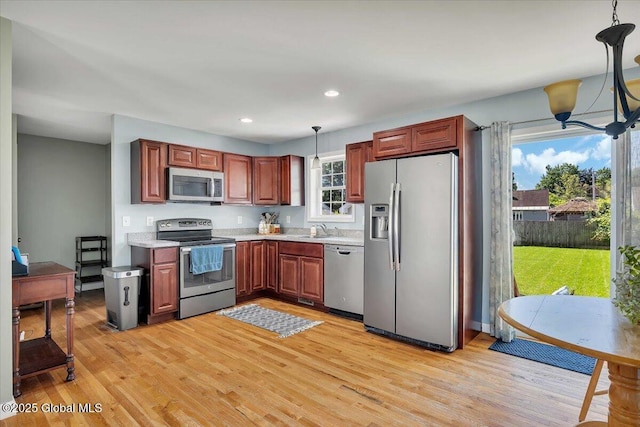 34 Wilson Ave, South Glens Falls, NY 12803 - kitchen with appliances with stainless steel finishes, light countertops, hanging light fixtures, light wood-style flooring, and recessed lighting