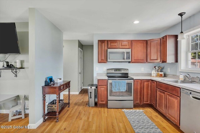 34 Wilson Ave, South Glens Falls, NY 12803 - kitchen featuring stainless steel appliances, light countertops, light wood-style flooring, hanging light fixtures, and recessed lighting
