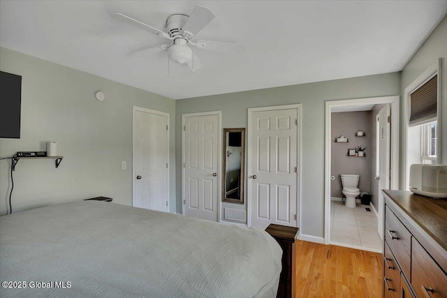 34 Wilson Ave, South Glens Falls, NY 12803 - bedroom with two closets, ensuite bathroom, light wood-style flooring, and ceiling fan