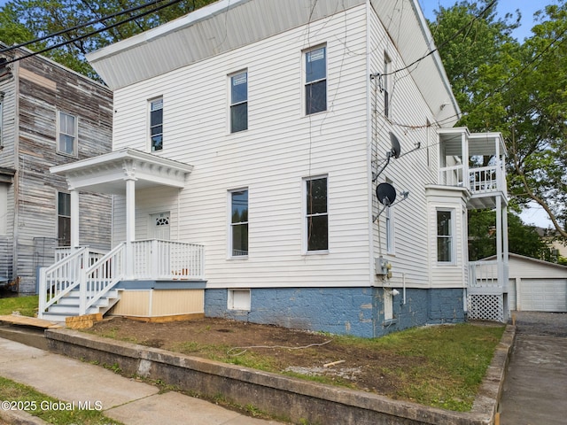 21 Kimball St, Amsterdam, NY 12010 - view of front facade featuring a balcony, an outdoor structure, and a detached garage