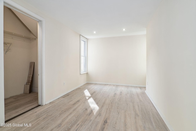 21 Kimball St, Amsterdam, NY 12010 - unfurnished bedroom with wood finished floors, recessed lighting, a spacious closet, baseboards, and a closet