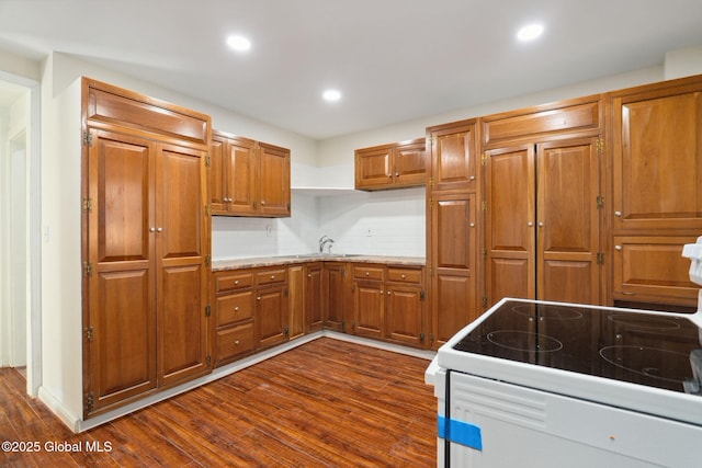 21 Kimball St, Amsterdam, NY 12010 - kitchen featuring dark wood-style flooring, brown cabinetry, white electric range oven, recessed lighting, and a sink
