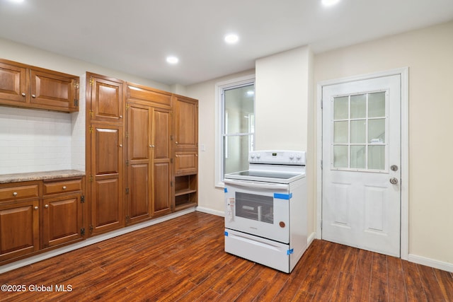 21 Kimball St, Amsterdam, NY 12010 - kitchen with white electric stove, dark wood-type flooring, tasteful backsplash, brown cabinetry, and recessed lighting