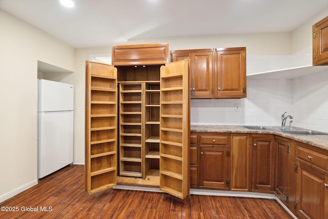 21 Kimball St, Amsterdam, NY 12010 - kitchen with freestanding refrigerator, a sink, dark wood-type flooring, decorative backsplash, and light stone counters