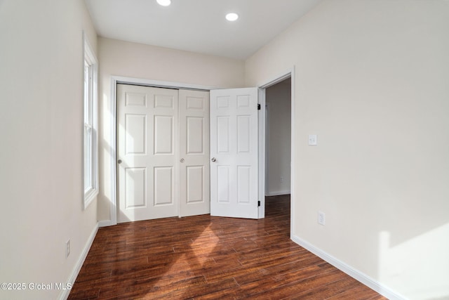 21 Kimball St, Amsterdam, NY 12010 - unfurnished bedroom featuring dark wood-style flooring, baseboards, recessed lighting, and a closet