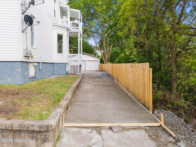 21 Kimball St, Amsterdam, NY 12010 - view of home's exterior with a balcony, a detached garage, and an outbuilding