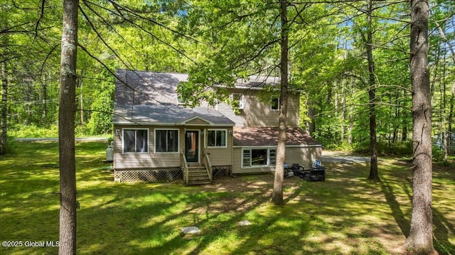 140 Redmond Rd, Moreau, NY 12831 - back of house with entry steps, a yard, and a wooded view