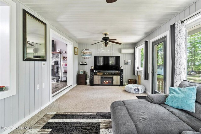 140 Redmond Rd, Moreau, NY 12831 - carpeted living room featuring healthy amount of natural light, ceiling fan, and wooden walls