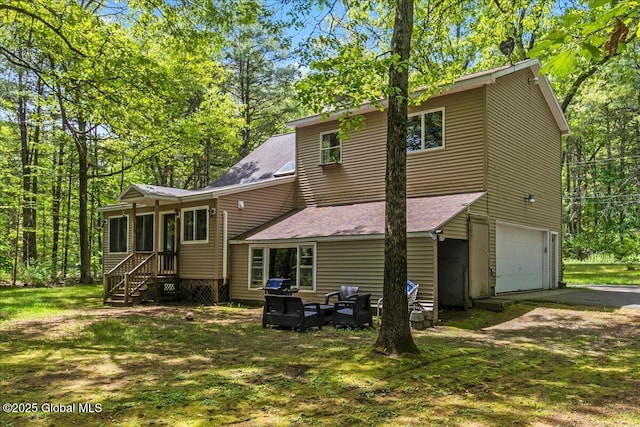 140 Redmond Rd, Moreau, NY 12831 - back of house featuring an attached garage, driveway, a shingled roof, and a yard
