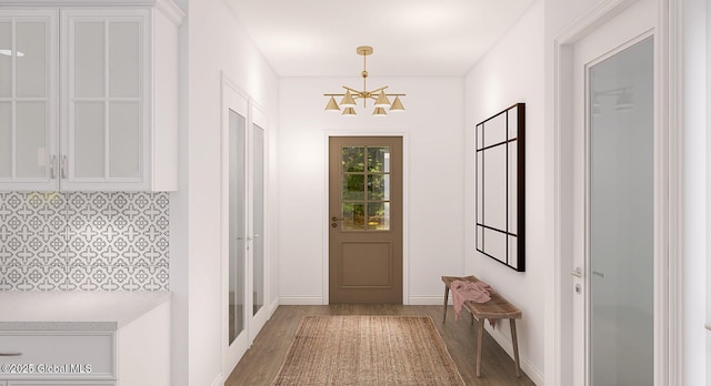 5 Seville Way, Bethlehem, NY 12158 - entryway featuring wood finished floors, a chandelier, and baseboards