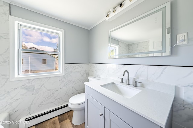 7116 Fuller Station Rd, Schenectady, NY 12303 - bathroom with a baseboard heating unit, vanity, toilet, tile walls, and ornamental molding