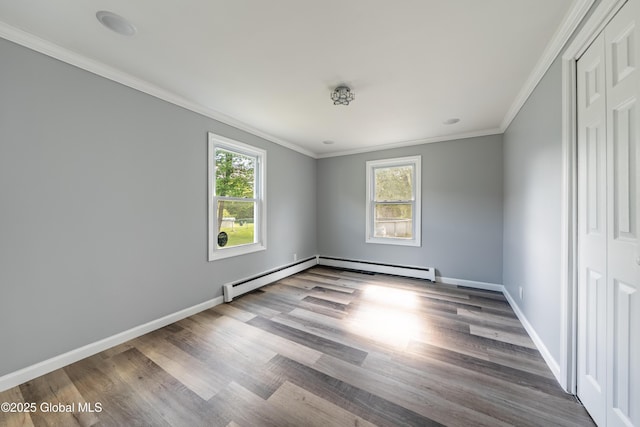 7116 Fuller Station Rd, Schenectady, NY 12303 - spare room featuring wood finished floors, a baseboard heating unit, ornamental molding, and baseboards