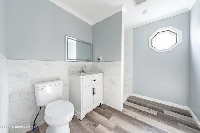 7116 Fuller Station Rd, Schenectady, NY 12303 - bathroom with tile walls, crown molding, vanity, toilet, and wood finished floors