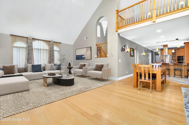 2085 Weast Rd, Princetown, NY 12137 - living area with high vaulted ceiling, light wood-style floors, baseboards, and arched walkways