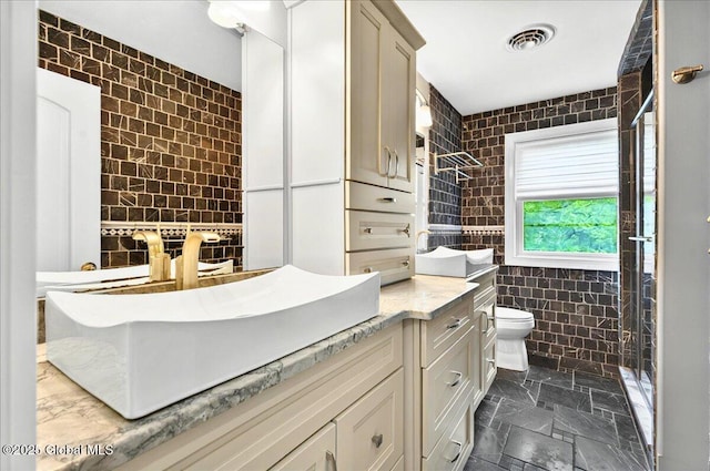 2085 Weast Rd, Princetown, NY 12137 - bathroom with tile walls, a stall shower, vanity, toilet, and stone finish floors